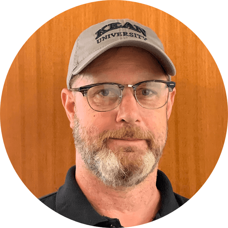 white man with a hat and glasses, smiling