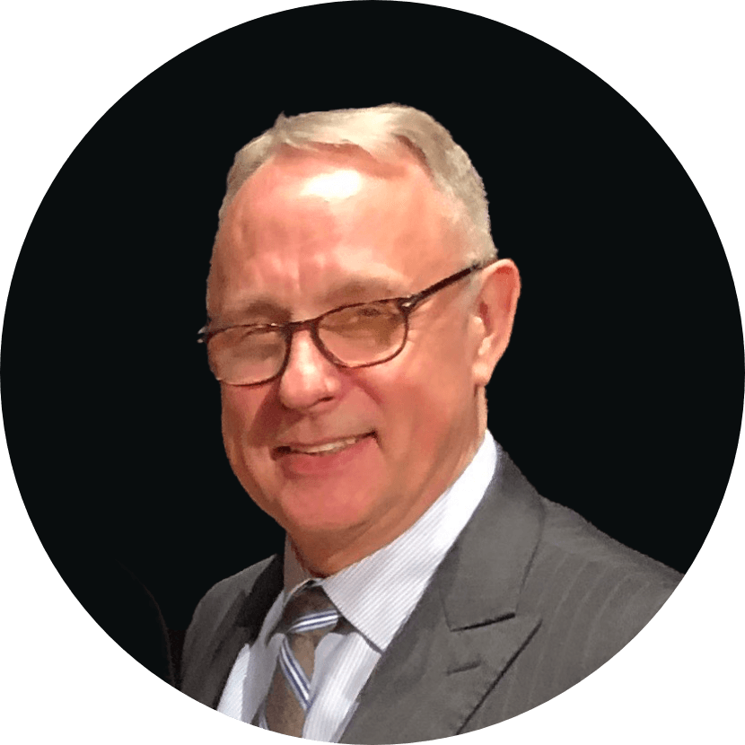 Steve, a white middle aged man in a suit, wearing glasses, and smiling at the camera