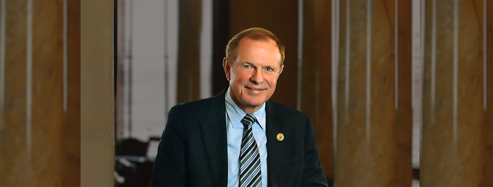 Senator Lesniak dressed in suit smiling