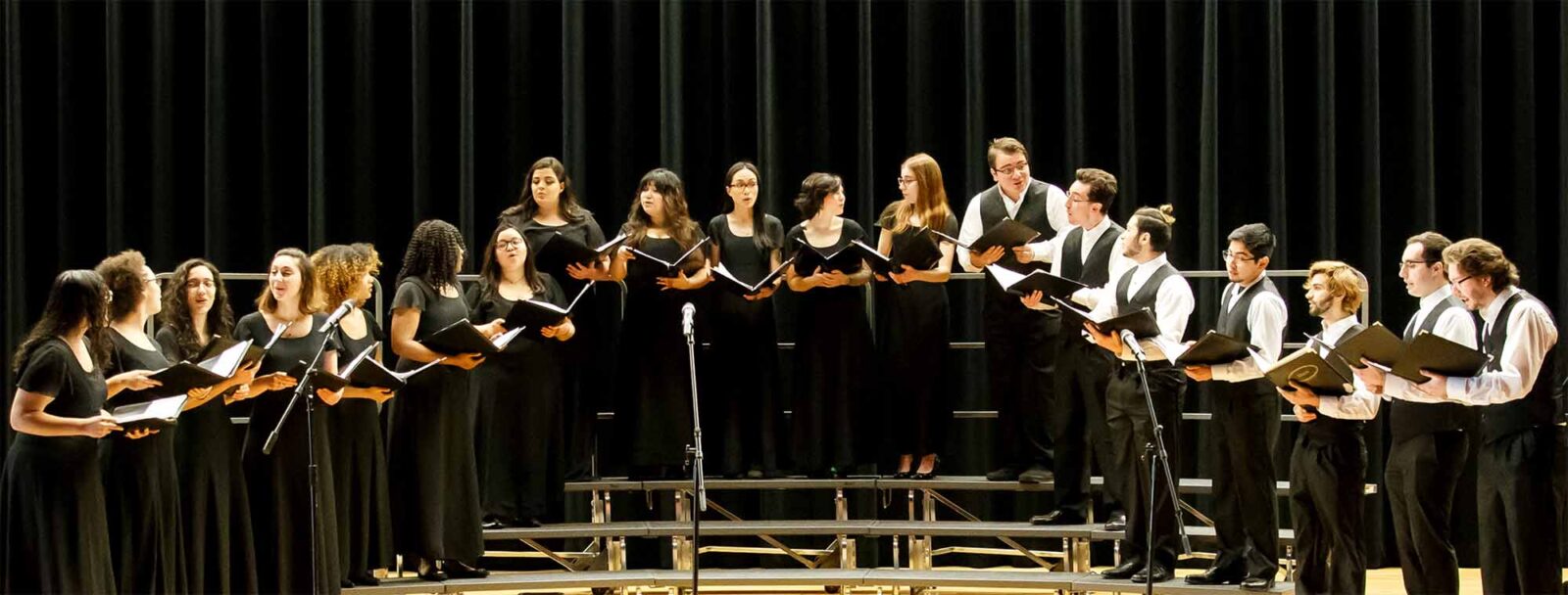 Concert Choir. Group with their music notes in hand, singing