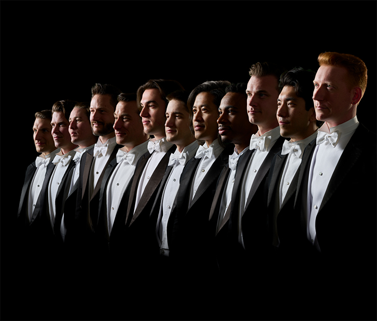 a group of man in black suits lined