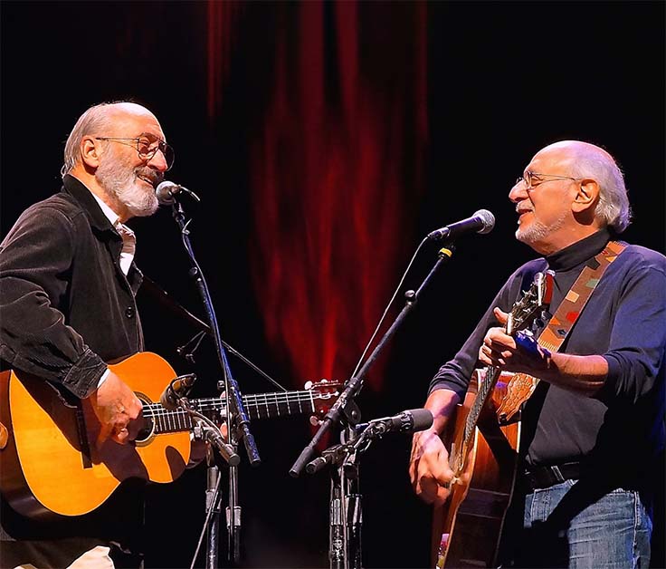 Peter and Paul playing guitar facing each other