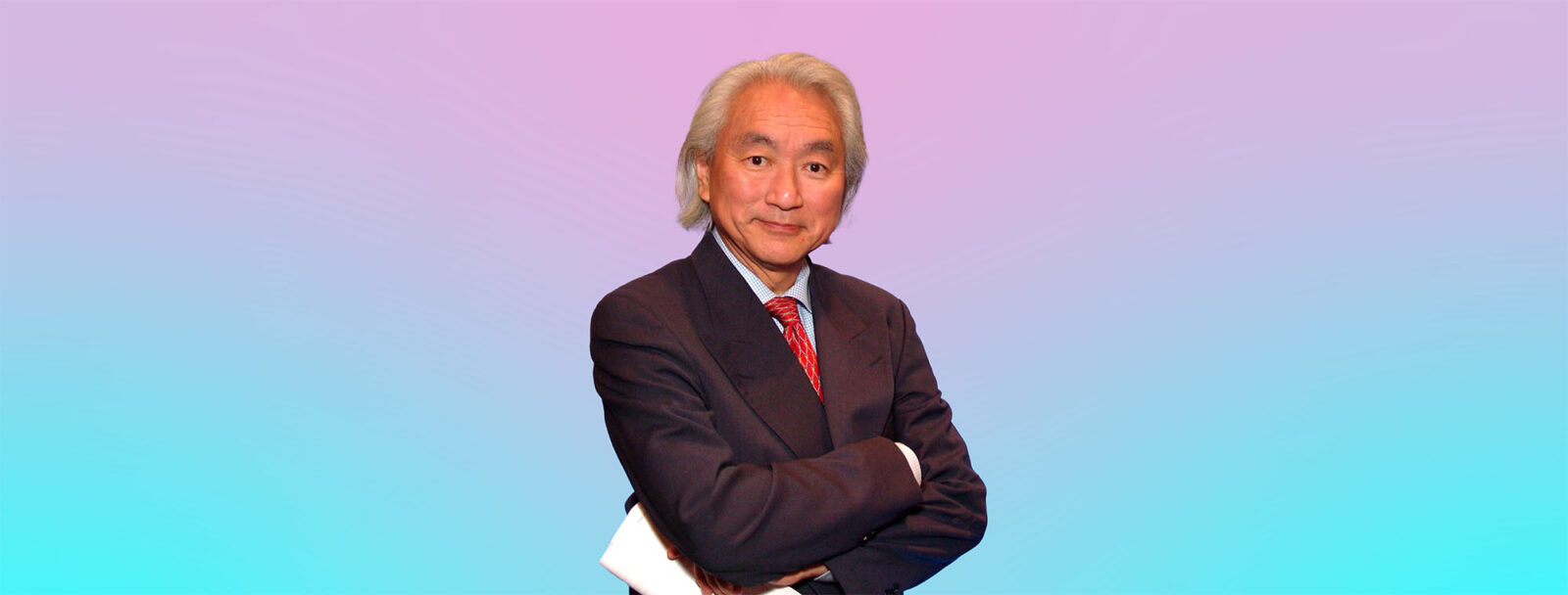 Michio Kaku, Asian white male with white hair, standing with his arms crossed holding what appears to be a bunch of papers