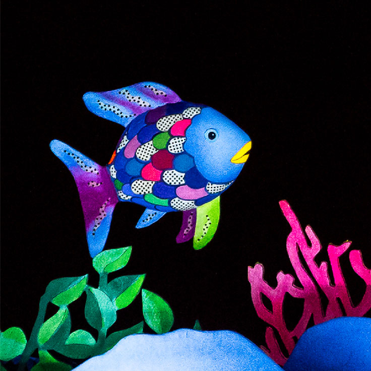 Rainbow fish under the sea, with plants and reefs underneath it.