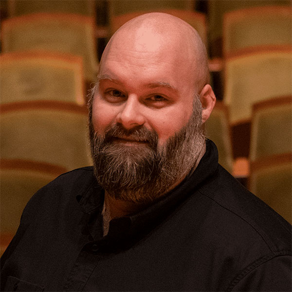 Headshot of a man with a beard and a mustache