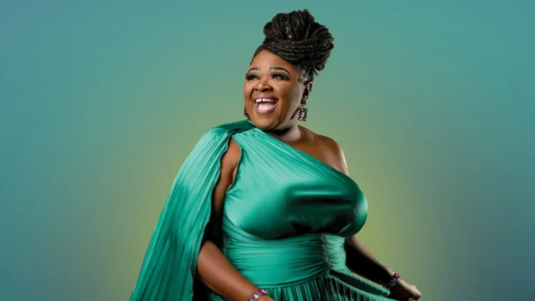 A woman in an exquisite green gown radiates joy and elegance, exuding confidence with a radiant smile. Her intricately styled hair and expressive demeanor reflect grace and poise against a softly hued background.